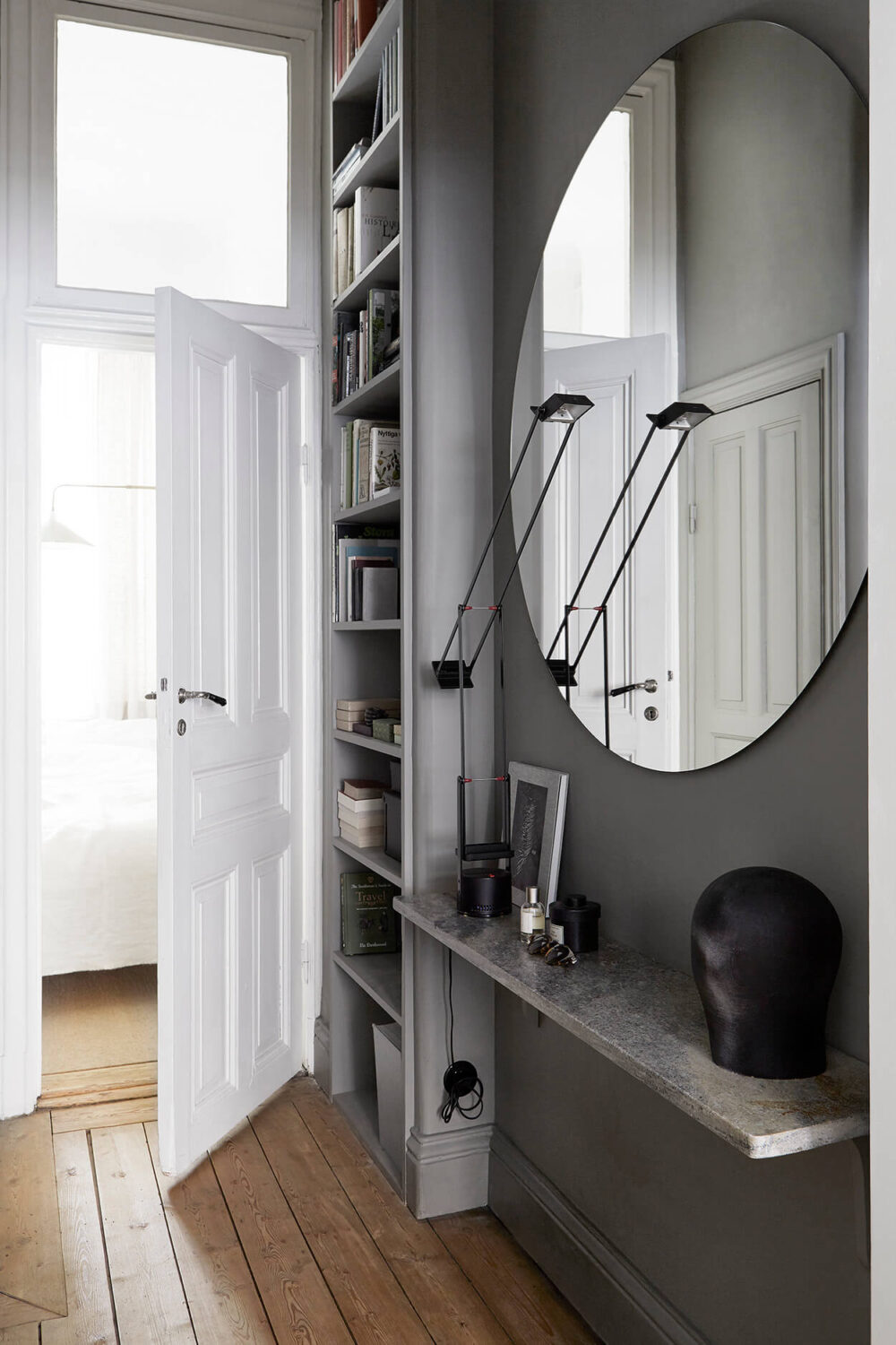 small entryway ideas with gray walls large round mirror floating shelf and floor to ceiling cabinets nordroom