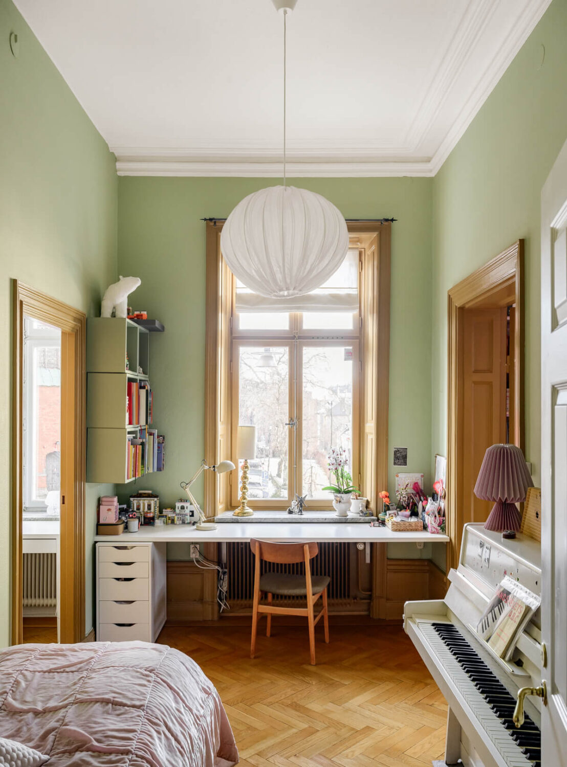 small green bedroom with desk under window