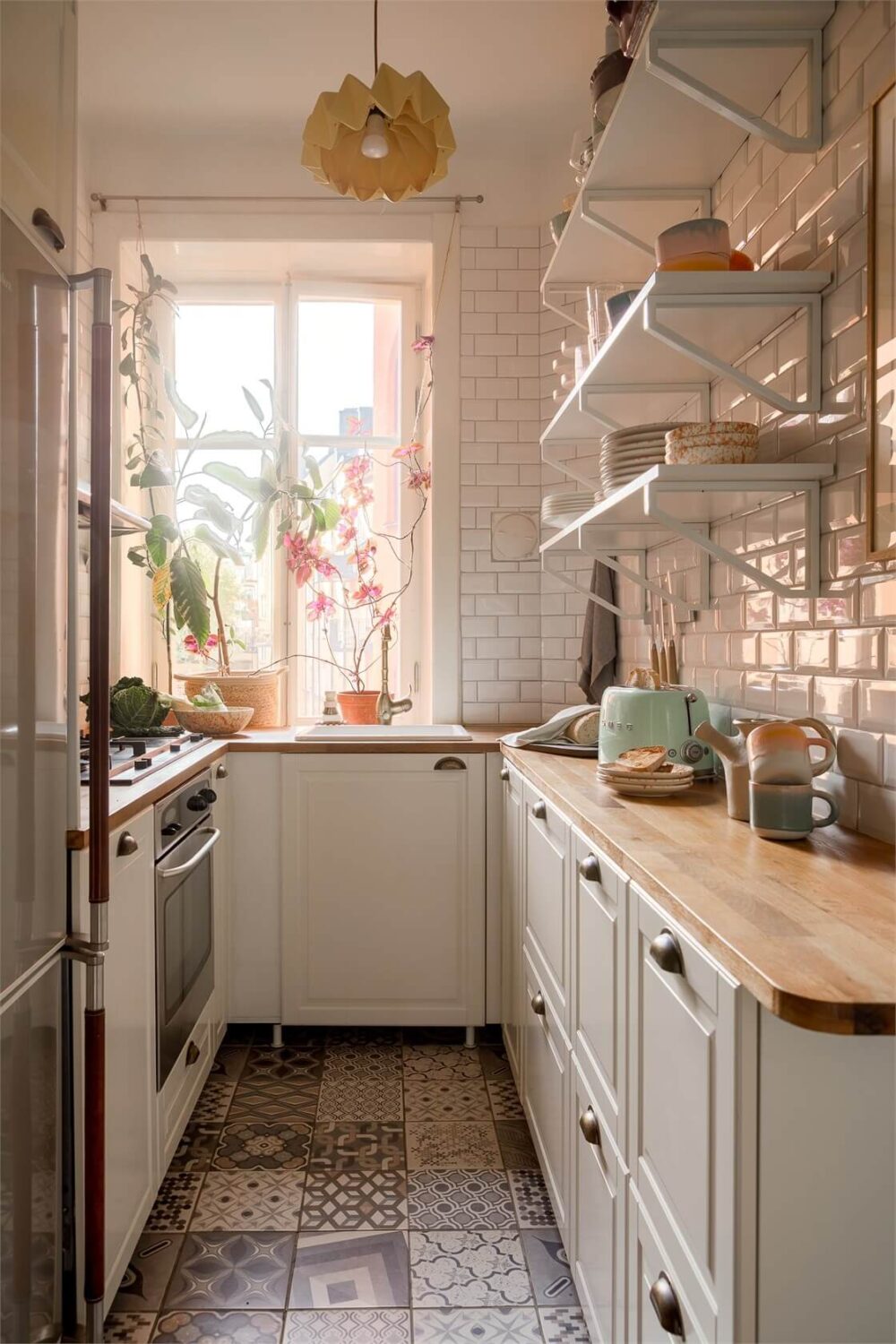 small kichen with white tiles cabinets and wooden worktop