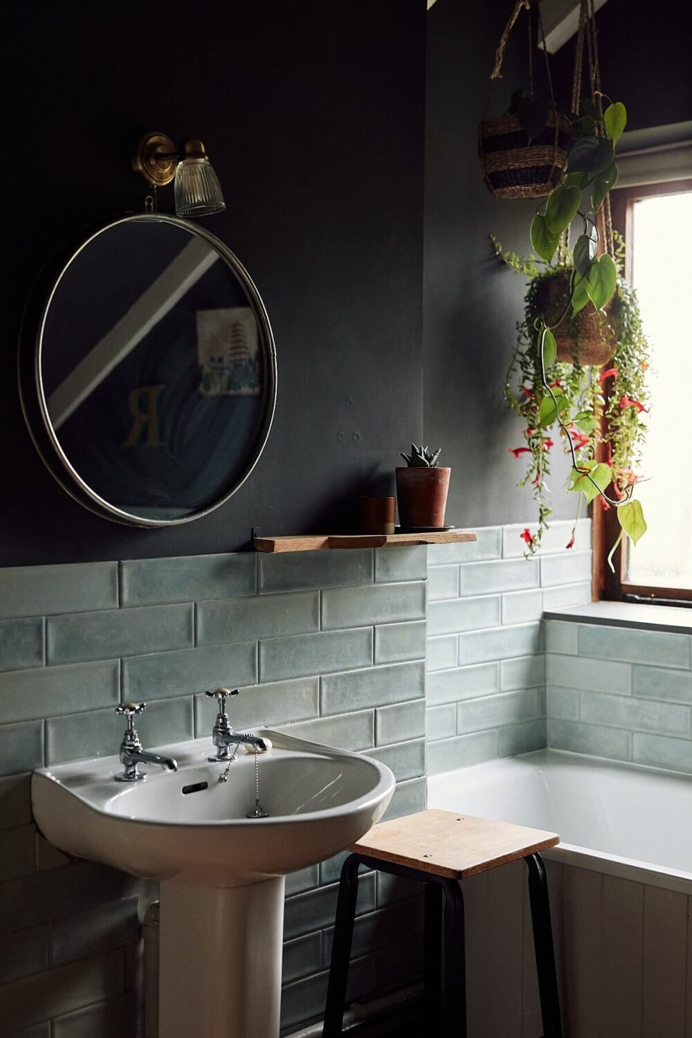 small moody bathroom with black walls and white tiles nordroom