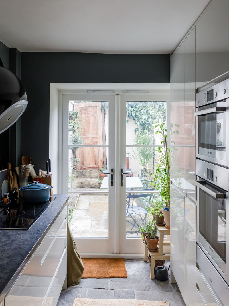 small white kitchen with garden doors