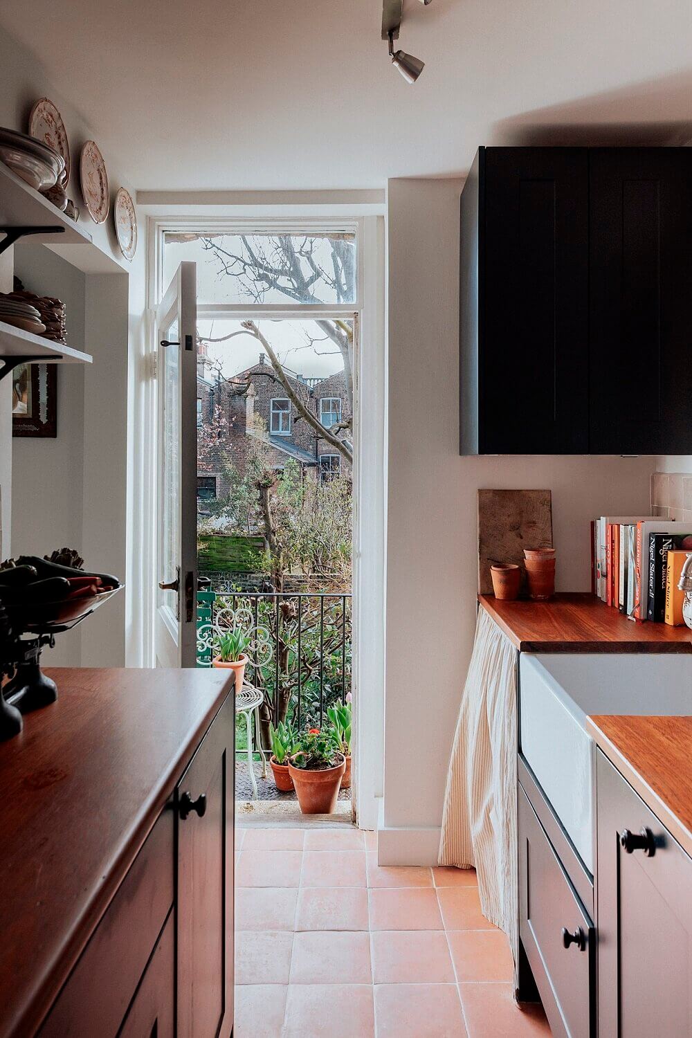 SmallBlueKitchenWithGardenViewsinaTinyLondonApartment TheNordroom8 The Pros and Cons of a Wooden Kitchen Countertop