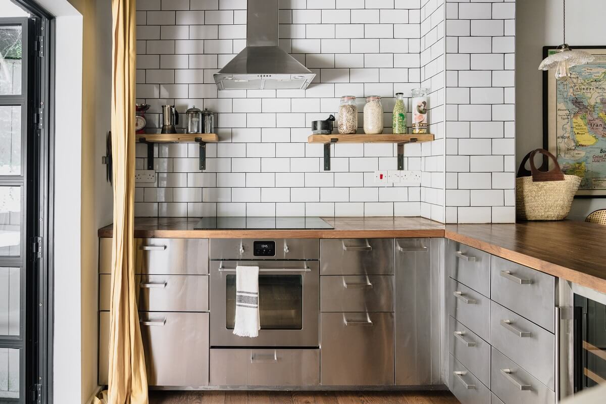 stainless steel kitchen with white subway tiles