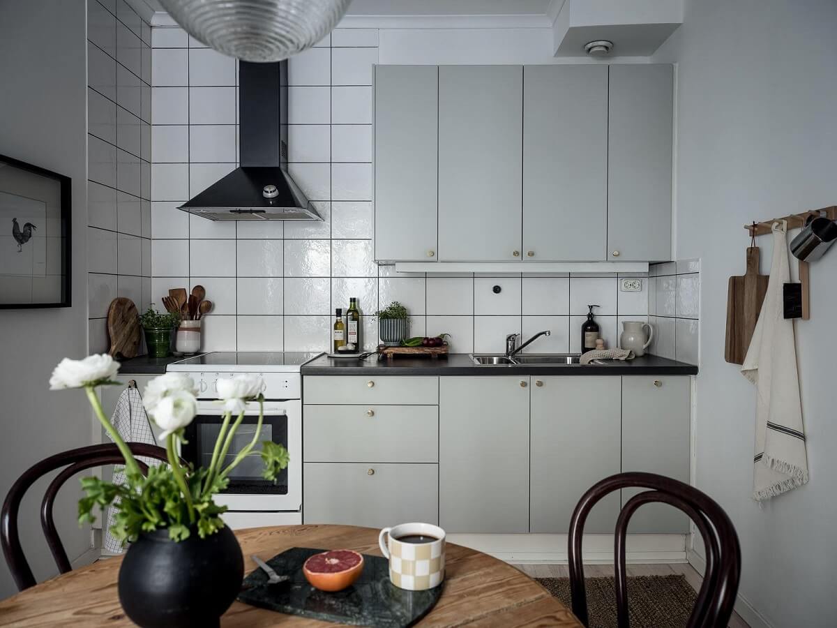 studio apartment kitchen light gray cabinets