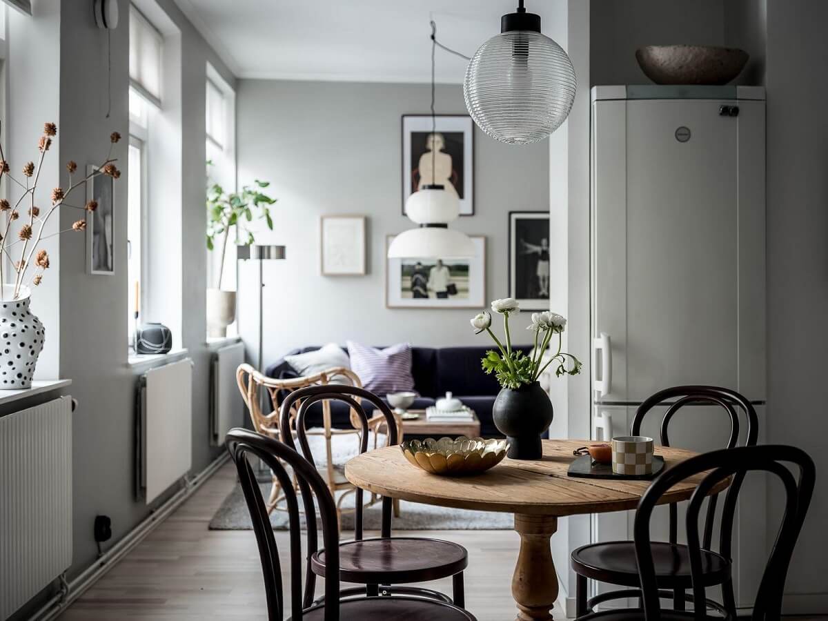 studio apartment with round dining table gray wals nordroom