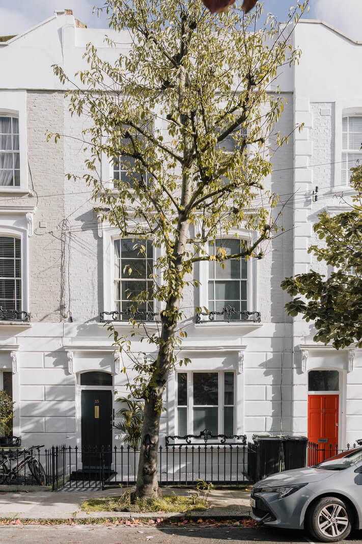 white apartment building A Charming One-Bedroom Apartment with a Courtyard Terrace
