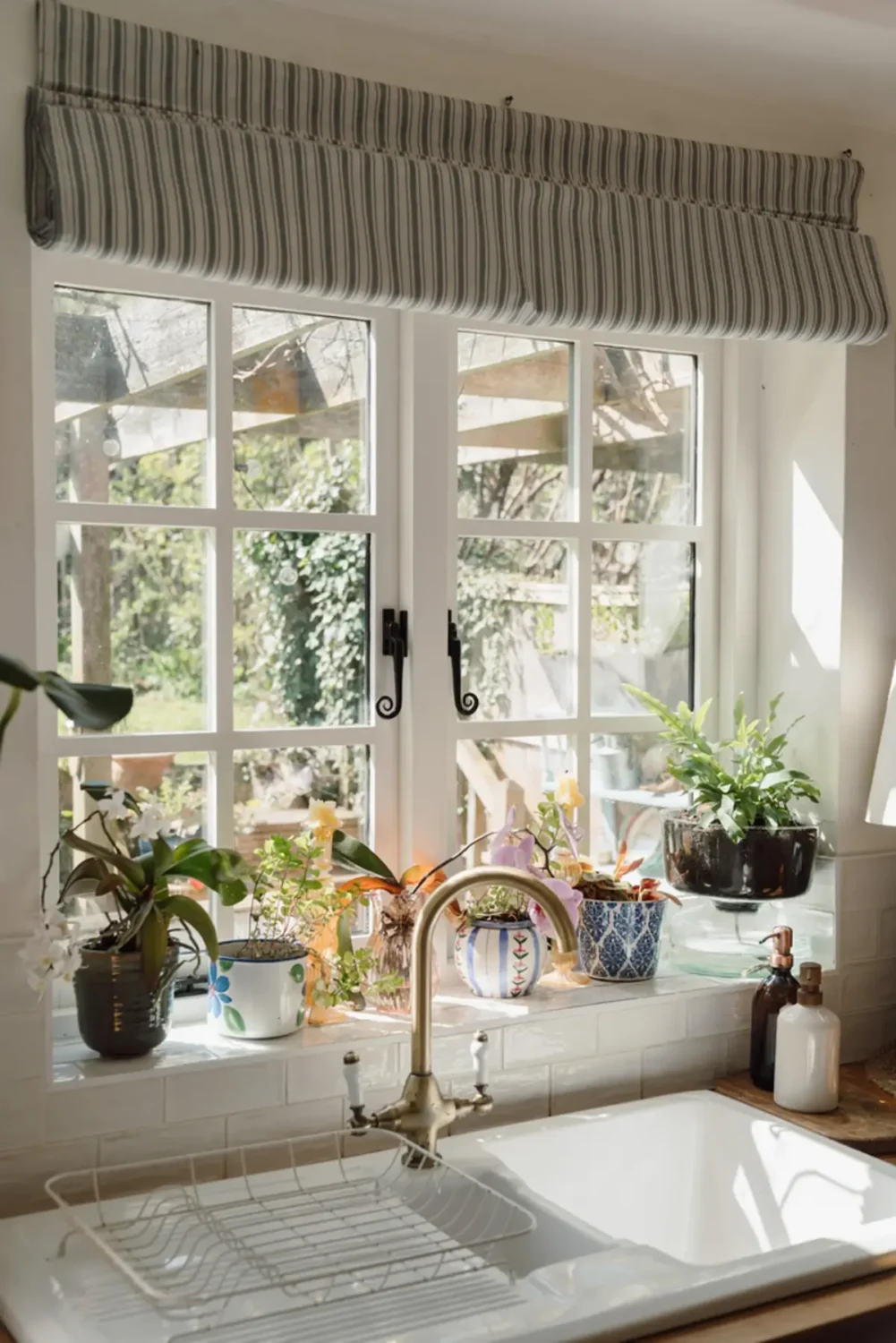 kitchen sink under window striped curtain