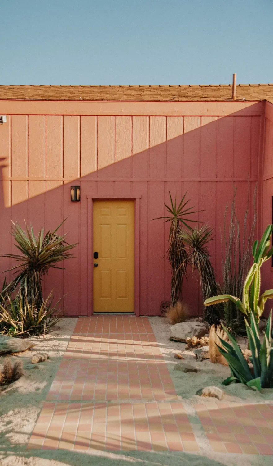 pink-exterior-airbnb-morongo-valley-yellow-front-door-nordroom