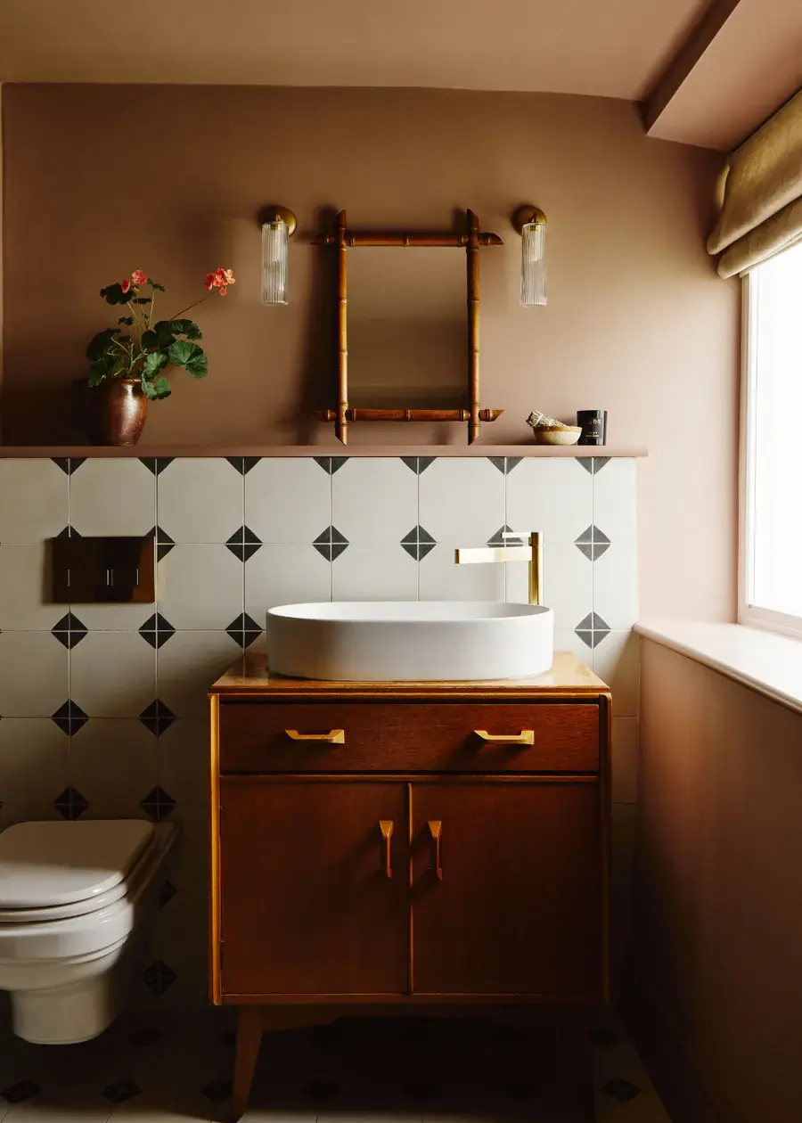 small brown bathroom with black and white tiles nordroom Pantone Color of the Year 2025: Mocha Mousse Interior Inspiration