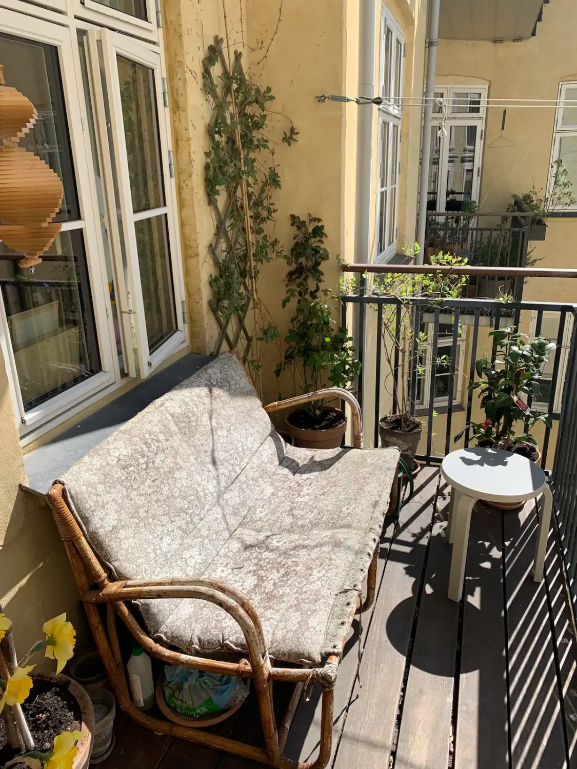 sunny balcony with rattan bench
